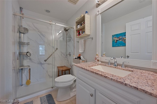 bathroom featuring a shower with door, tile patterned flooring, vanity, and toilet