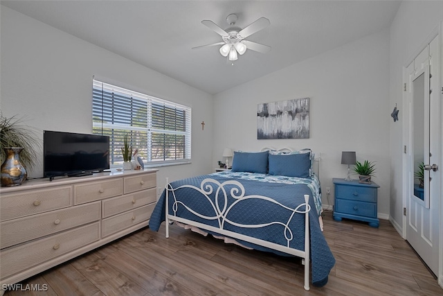 bedroom featuring ceiling fan, vaulted ceiling, and wood-type flooring