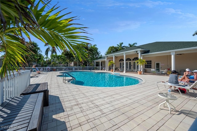 view of swimming pool featuring ceiling fan and a patio area