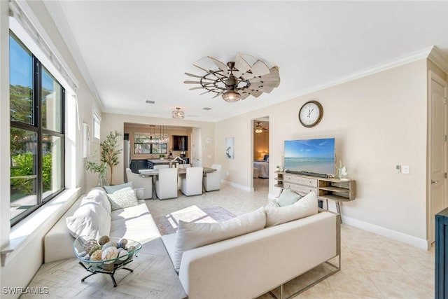 tiled living room with ceiling fan, ornamental molding, and plenty of natural light