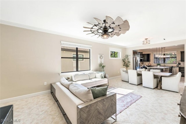 tiled living room with ceiling fan, crown molding, and a healthy amount of sunlight