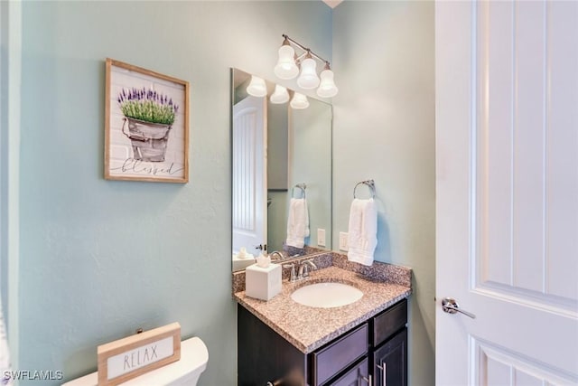 bathroom with toilet and vanity