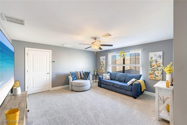 carpeted living room with ceiling fan