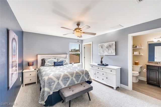 carpeted bedroom with ceiling fan and connected bathroom