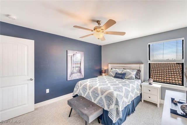 bedroom featuring ceiling fan and light carpet