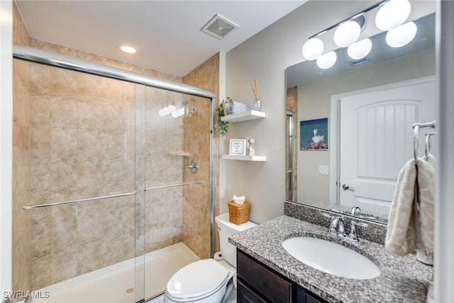 bathroom featuring toilet, walk in shower, and vanity