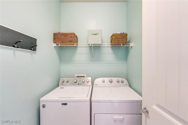 laundry room featuring separate washer and dryer