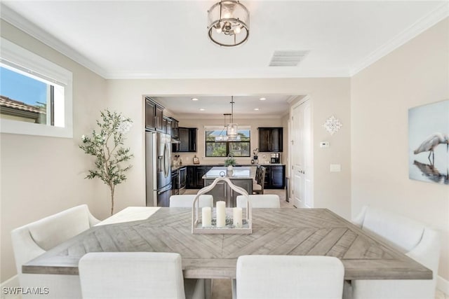 dining space featuring crown molding