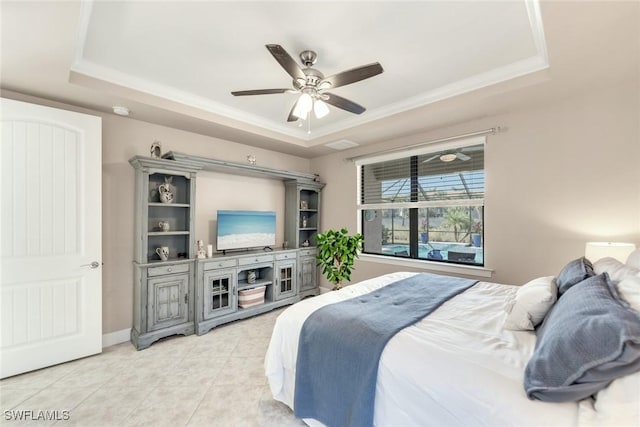 bedroom with ornamental molding, a raised ceiling, ceiling fan, and light tile patterned floors