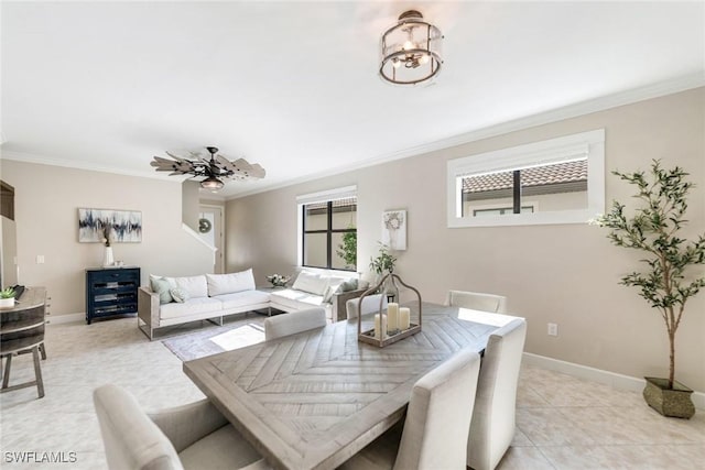 dining area featuring ceiling fan, light tile patterned flooring, and ornamental molding