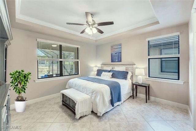 bedroom with ornamental molding, a raised ceiling, ceiling fan, and light tile patterned floors