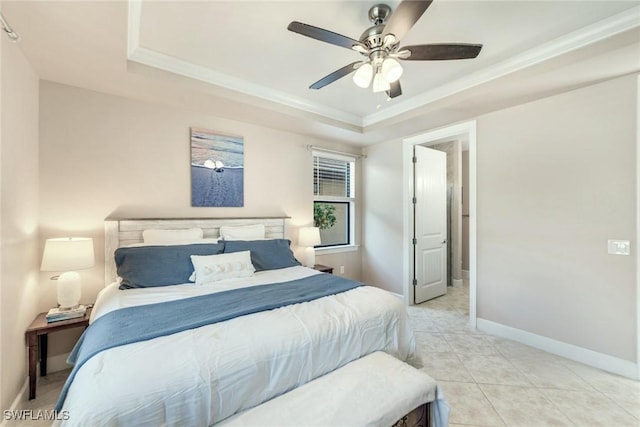 tiled bedroom featuring ceiling fan, a tray ceiling, and crown molding