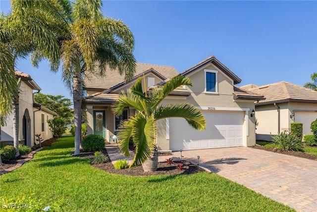 view of front of house with a garage and a front lawn