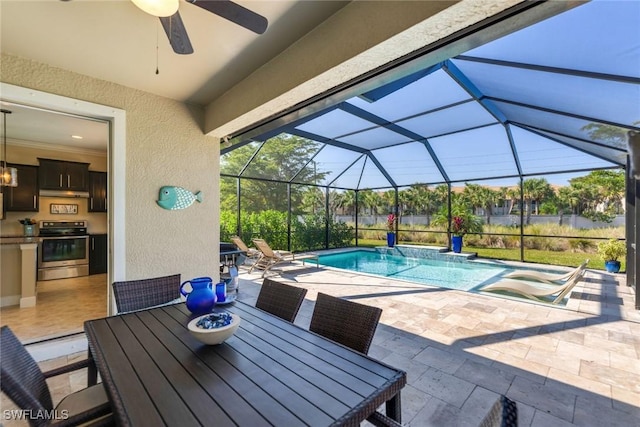 view of swimming pool with ceiling fan, a patio, glass enclosure, and area for grilling