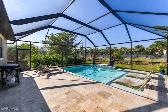 view of pool featuring a patio and glass enclosure