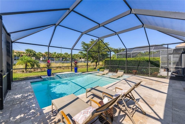 view of swimming pool with glass enclosure and a patio area