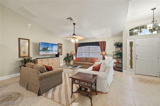 living room with lofted ceiling, a healthy amount of sunlight, and light tile patterned flooring