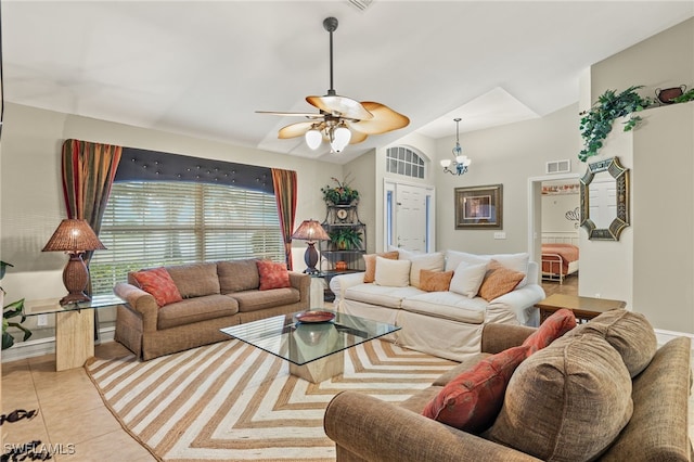 living room featuring ceiling fan with notable chandelier and light tile patterned flooring