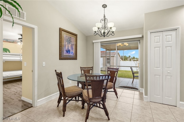 dining room with lofted ceiling, light tile patterned floors, and ceiling fan with notable chandelier