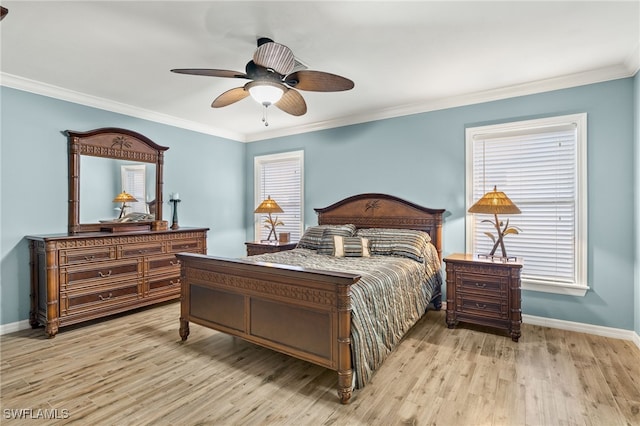 bedroom with light hardwood / wood-style floors, ceiling fan, and crown molding