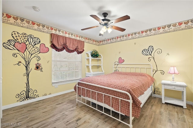 bedroom featuring hardwood / wood-style flooring and ceiling fan