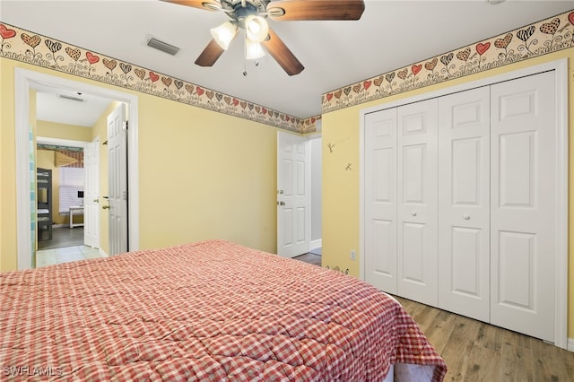 bedroom with a closet, ceiling fan, and light hardwood / wood-style flooring