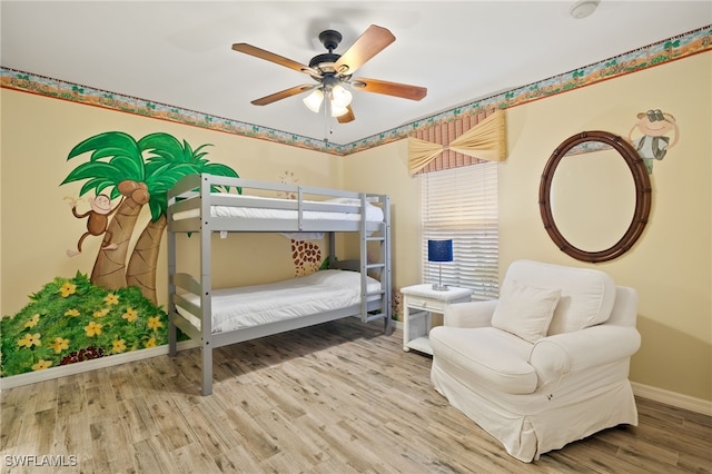 bedroom with hardwood / wood-style floors and ceiling fan