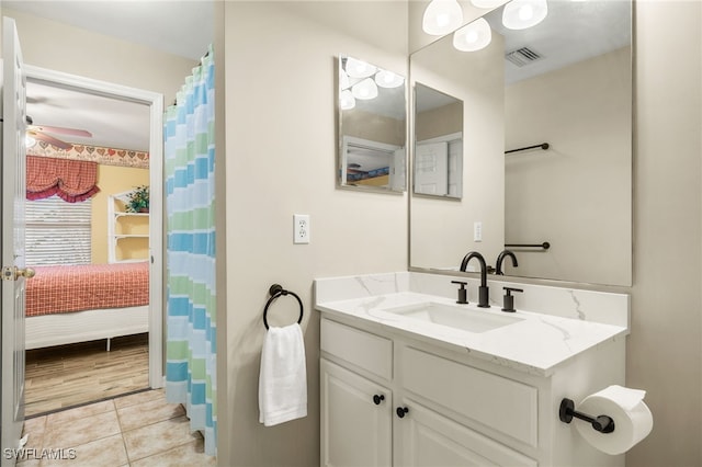 bathroom featuring tile patterned floors, ceiling fan, and vanity