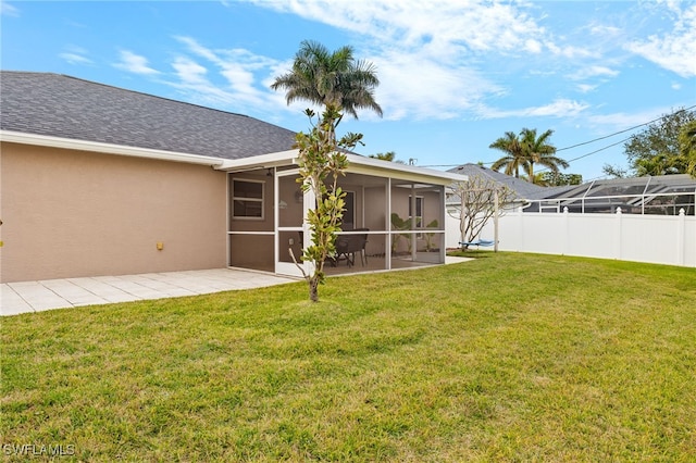 view of yard with a sunroom and a patio area