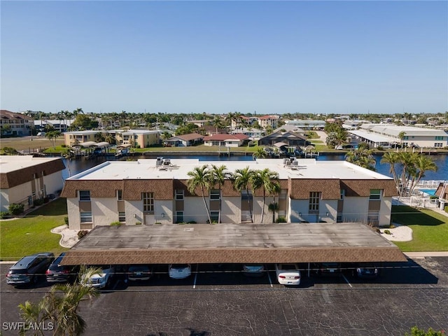 drone / aerial view with a residential view and a water view