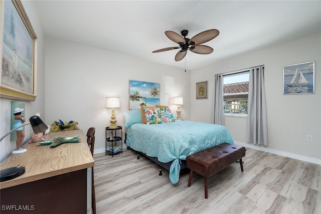 bedroom featuring light wood-style floors, baseboards, and a ceiling fan