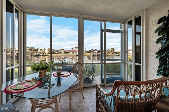 sunroom / solarium with a water view