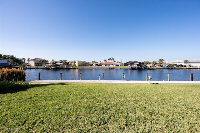 exterior space with a water view and a lawn