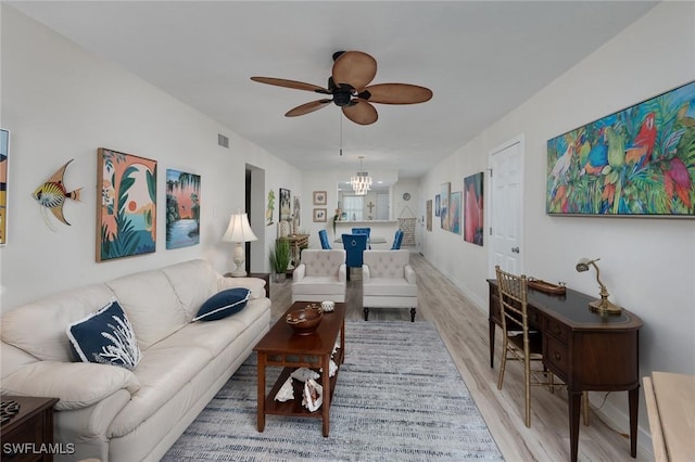 living room with a ceiling fan, wood finished floors, and visible vents