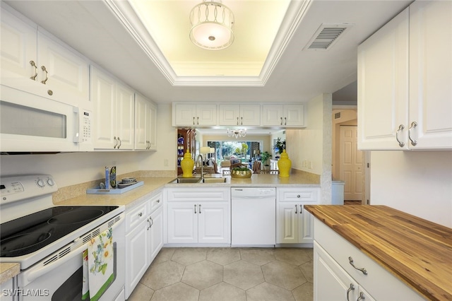 kitchen with sink, wood counters, crown molding, white appliances, and white cabinets