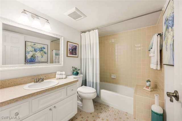 full bathroom featuring tile patterned flooring, vanity, toilet, and shower / bath combo with shower curtain