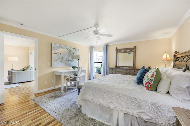 bedroom featuring ceiling fan, light hardwood / wood-style floors, and crown molding