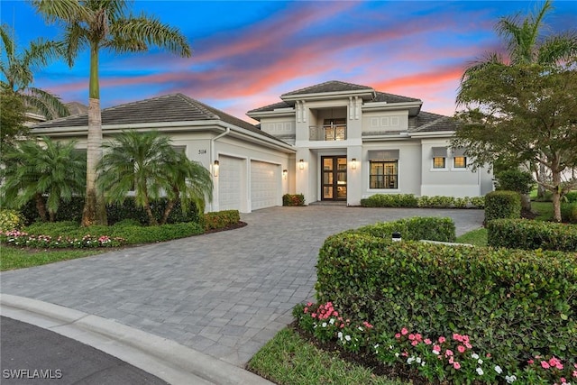 view of front of property featuring french doors and a balcony