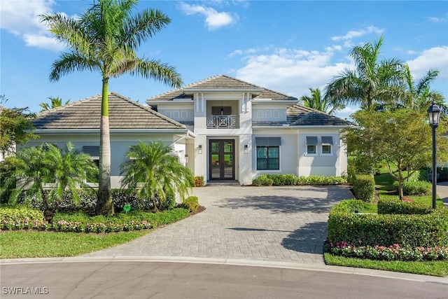 mediterranean / spanish home featuring french doors and a balcony