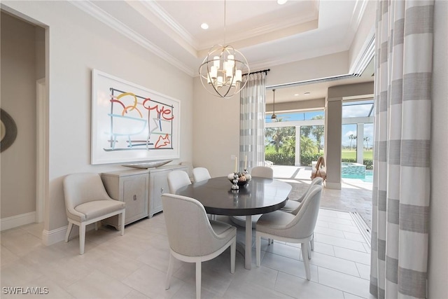 tiled dining space featuring an inviting chandelier and a tray ceiling