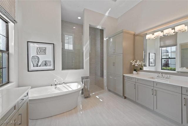 bathroom featuring tile patterned flooring, vanity, shower with separate bathtub, and a wealth of natural light