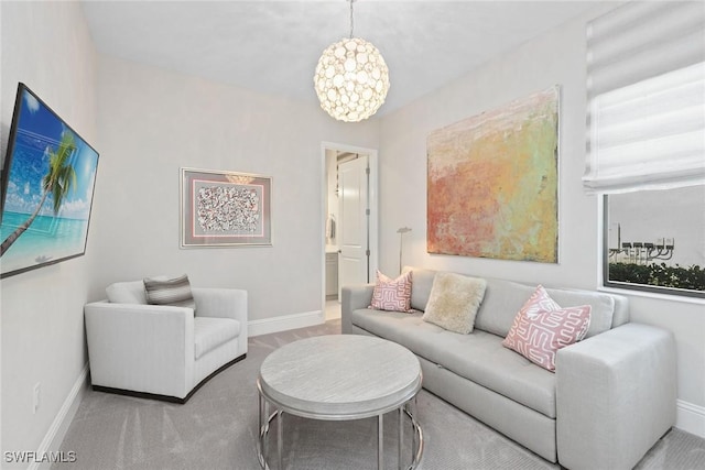 living room with a notable chandelier and carpet floors