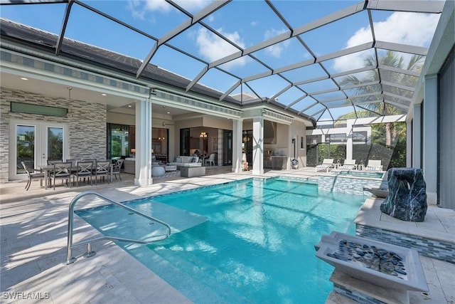 view of swimming pool featuring an outdoor living space, glass enclosure, and a patio area