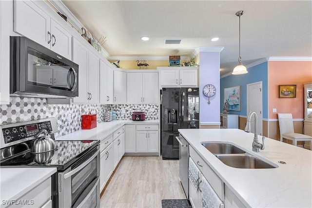 kitchen featuring white cabinetry, sink, hanging light fixtures, tasteful backsplash, and black appliances