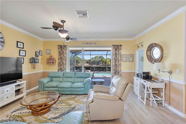 living room with light hardwood / wood-style flooring, ceiling fan, and ornamental molding