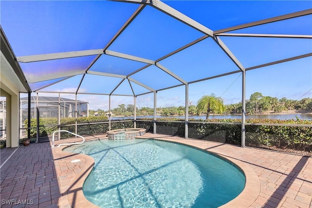 view of pool with glass enclosure, a water view, an in ground hot tub, and a patio