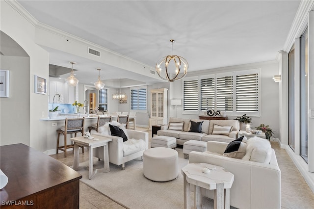 tiled living room with crown molding and a notable chandelier