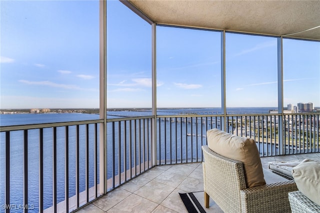 unfurnished sunroom with a water view