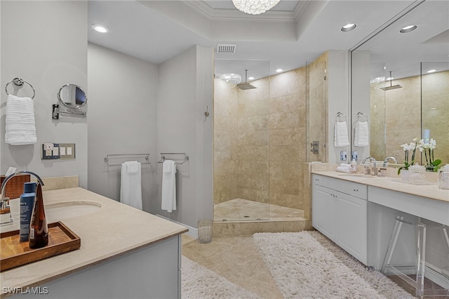 bathroom with vanity, ornamental molding, tiled shower, and a chandelier