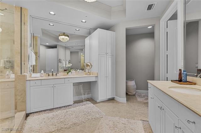 bathroom with vanity, a raised ceiling, and crown molding